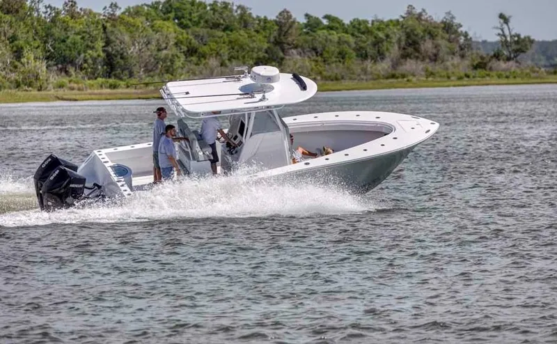 Slide: The Image of 2025 Onslow Bay 27 Offshore Edition boat cruising on a lake. - 2