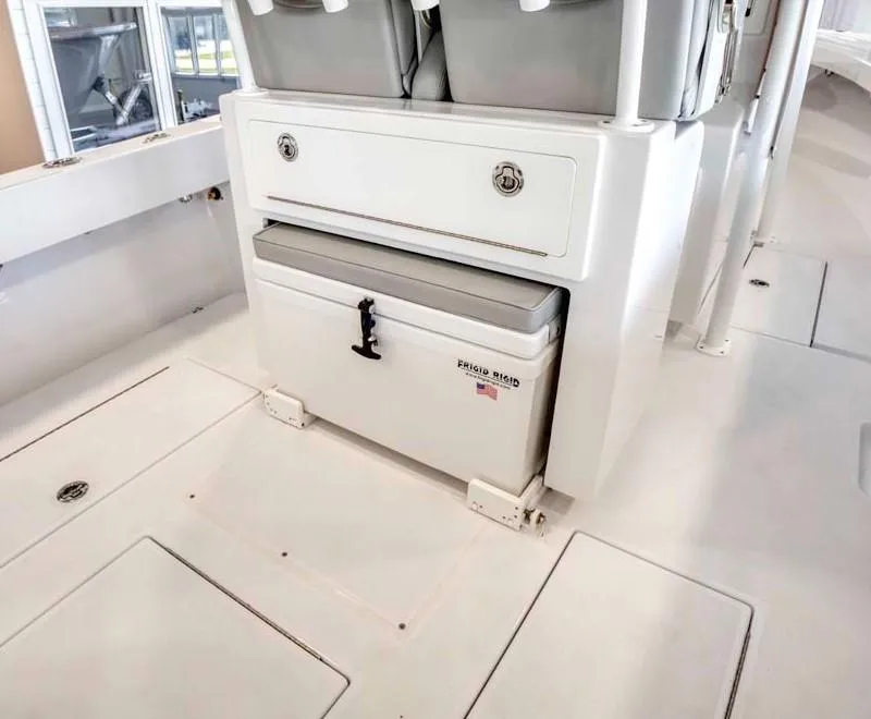 Slide: The Image of Onslow Bay 27 Offshore Edition 2025 boat interior with storage and cooler. - 7