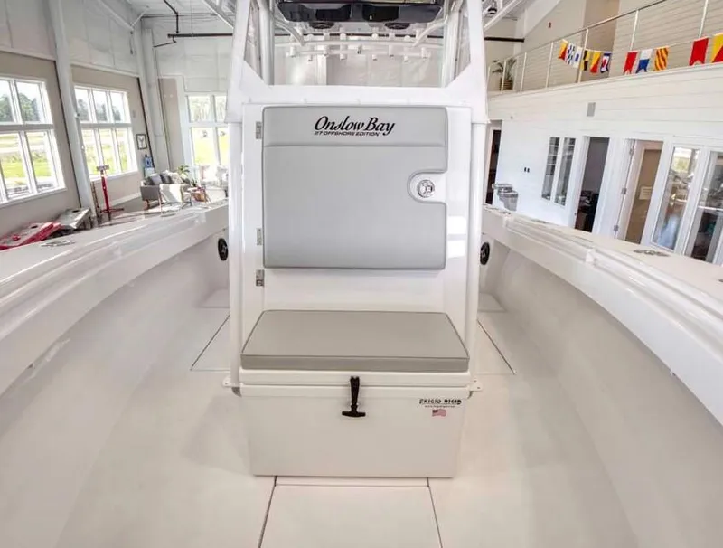 Slide: The Image of 2025 Onslow Bay 27 Offshore Edition boat interior with seating and storage. - 8