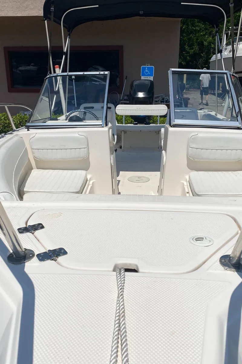 Slide: The Image of 2005 Key West 2020 SE boat interior with seating and steering console. - 11