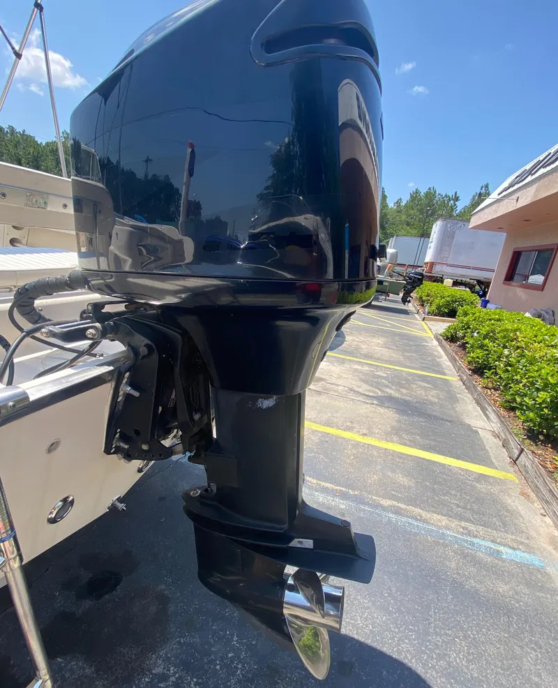 Slide: The Image of Close-up of a 2005 Key West 2020 SE boat motor in a parking lot. - 12