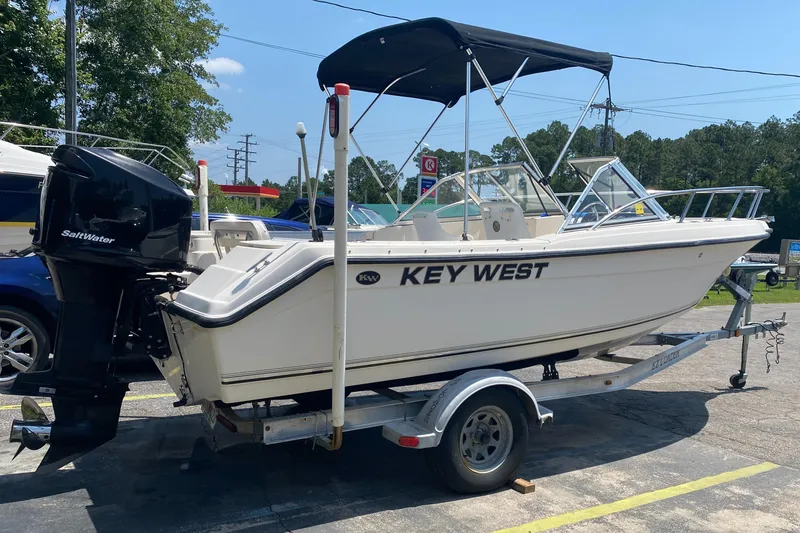 Slide: The Image of 2005 Key West 2020 SE boat on trailer with outboard motor. - 2