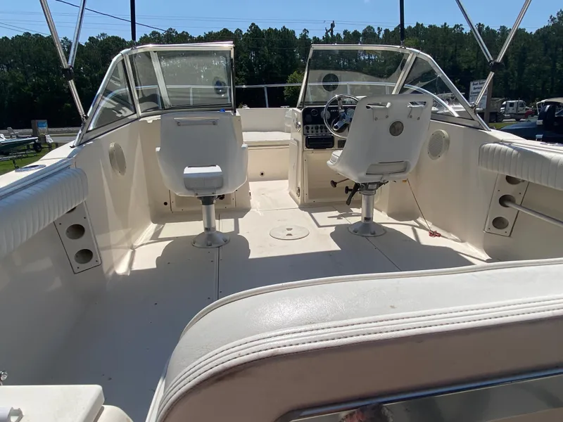 Slide: The Image of 2005 Key West 2020 SE boat interior with dual captain chairs and open deck. - 6