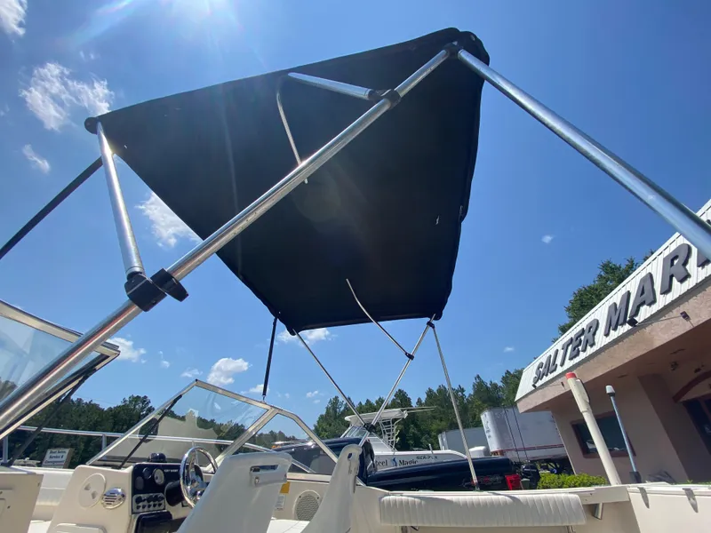 Slide: The Image of Key West 2020 SE 2005 model boat with canopy at a marina under a clear blue sky. - 8