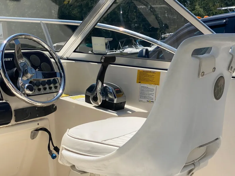 Slide: The Image of 2005 Key West 2020 SE boat cockpit with steering wheel and control panel. - 9