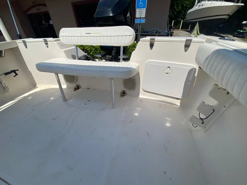 Slide: The Image of Key West 2020 SE 2005 boat interior with white seating and storage compartments. - 10