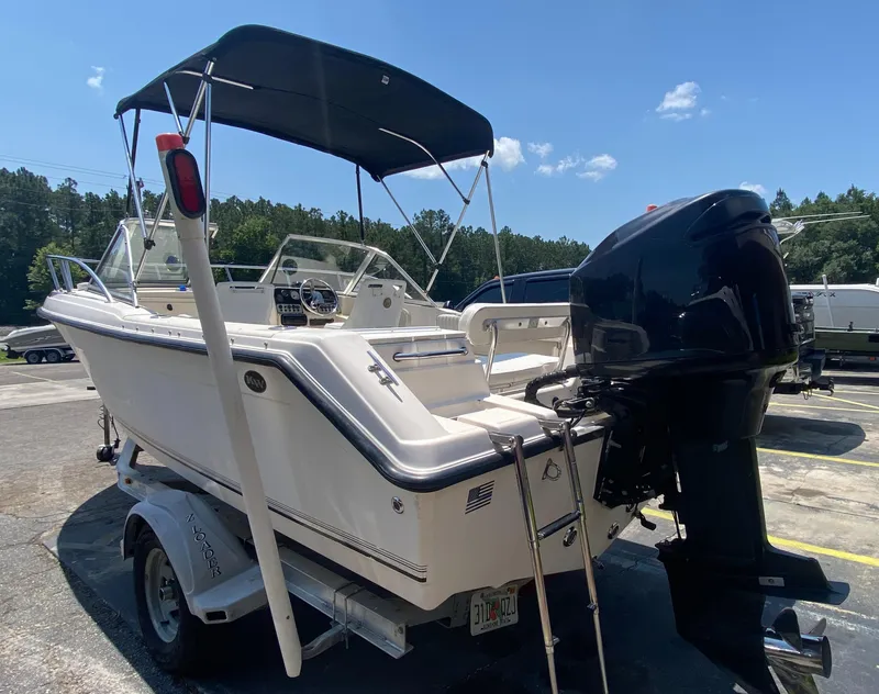 Slide: The Image of Key West 2020 SE 2005 model boat on trailer with outboard motor. - 3