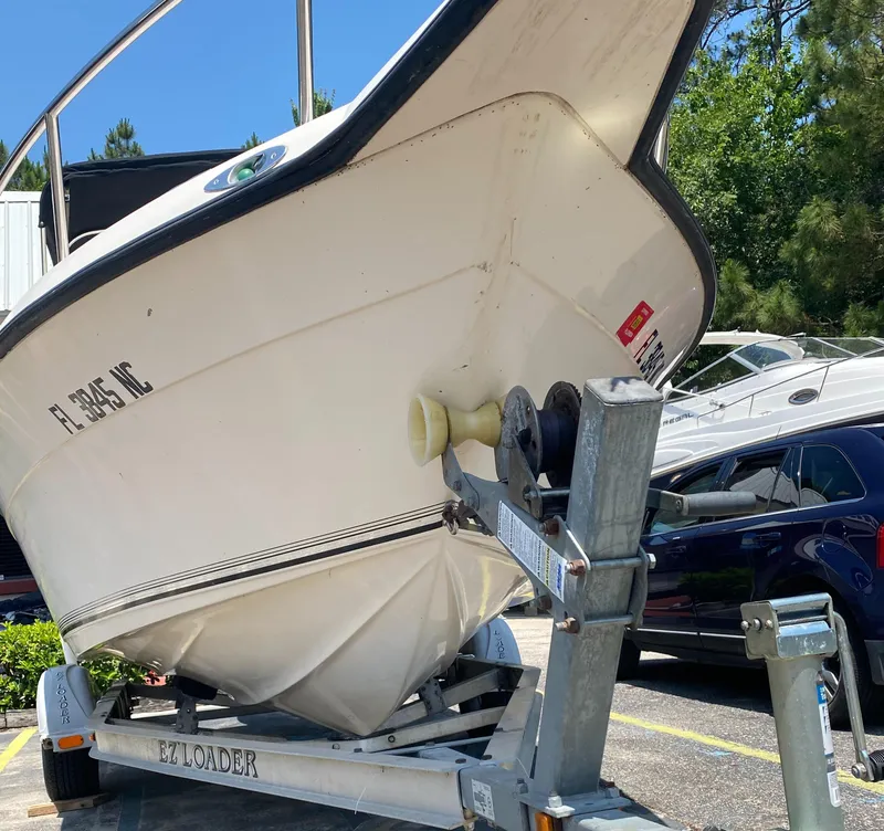 Slide: The Image of Key West 2020 SE 2005 boat on EZ Loader trailer in parking lot. - 4