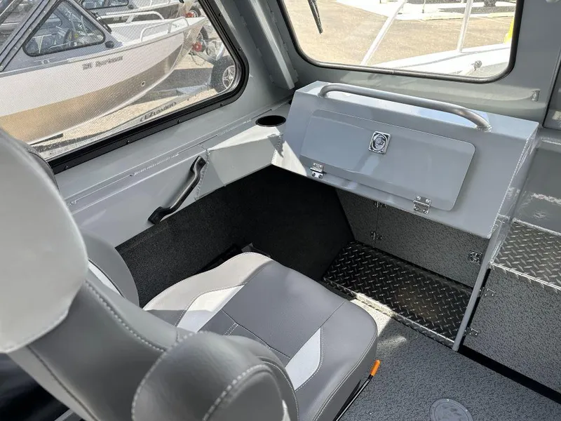 Slide: The Image of Interior of 2024 Hewescraft 240 Ocean Pro ET boat, featuring seating and storage. - 7