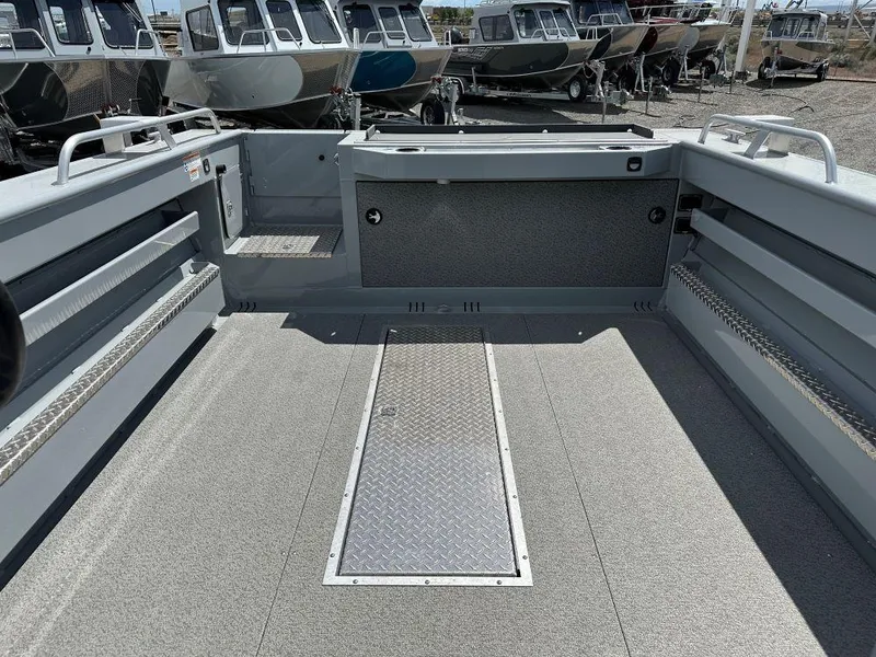 Slide: The Image of 2024 Hewescraft 240 Ocean Pro ET boat interior with spacious deck and storage compartments. - 9