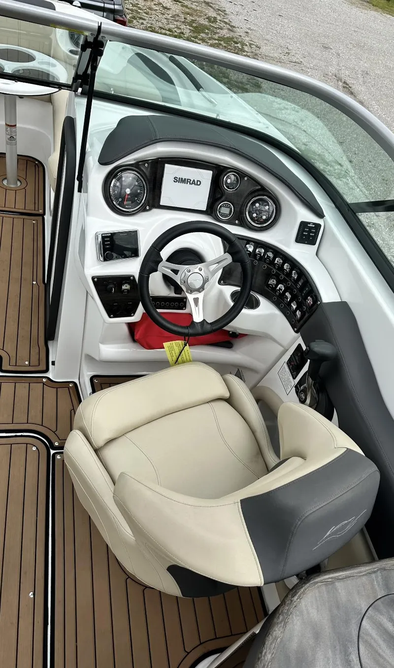 Slide: The Image of 2018 Rinker QX29 BR boat cockpit with steering wheel and control panel. - 8