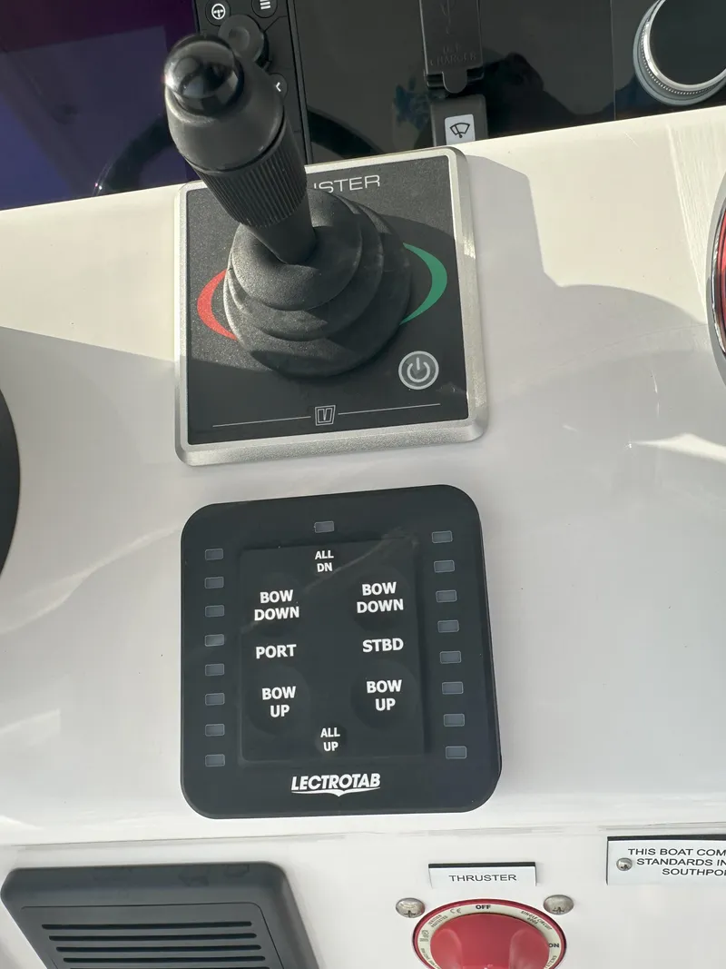 Slide: The Image of Control panel of a 2024 Southport 30 FE boat with Lectrotab trim tab switches. - 12