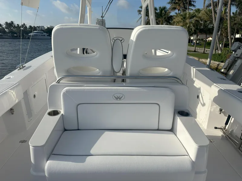 Slide: The Image of 2024 Southport 30 FE boat interior with white seating and cup holders. - 13
