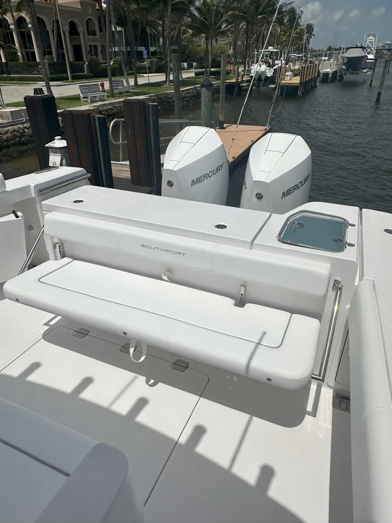 Slide: The Image of 2024 Southport 30 FE boat with dual Mercury engines docked at a marina. - 15