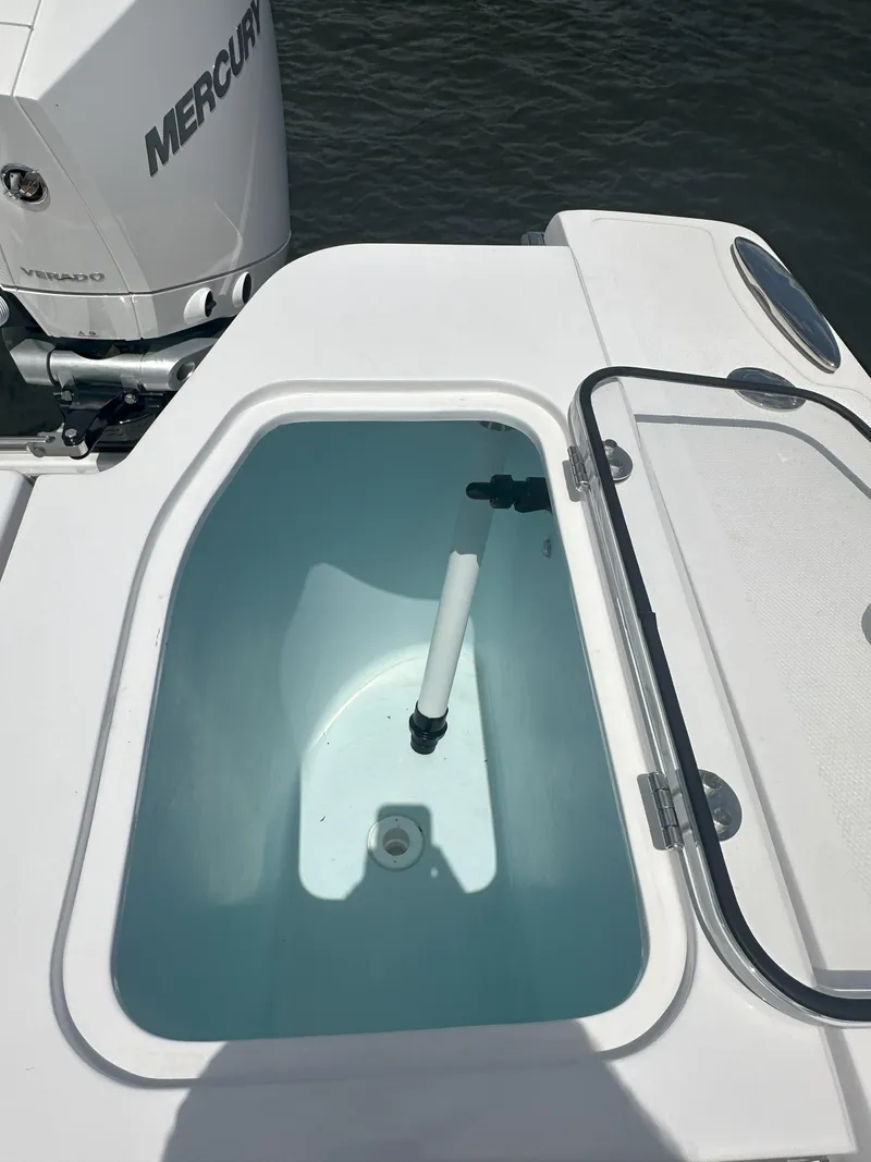 Slide: The Image of 2024 Southport 30 FE boat livewell with open lid and Mercury outboard engine. - 16