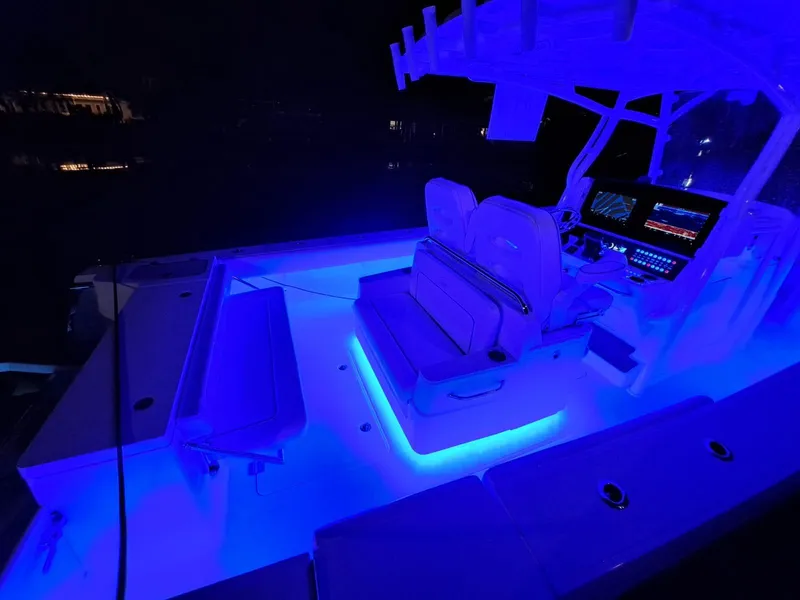 Slide: The Image of 2024 Southport 30 FE boat interior with blue LED lighting at night. - 20