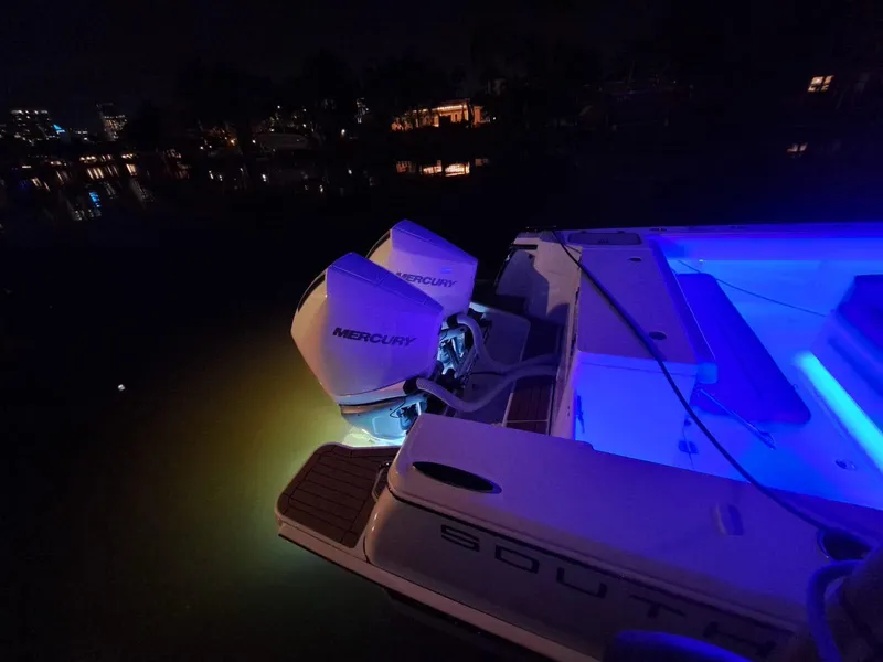 Slide: The Image of 2024 Southport 30 FE boat with Mercury engines illuminated at night. - 27