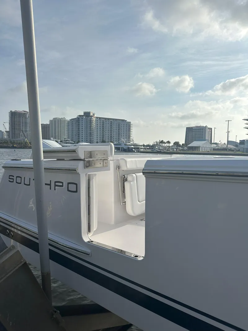 Slide: The Image of 2024 Southport 30 FE boat docked with city skyline in the background. - 4