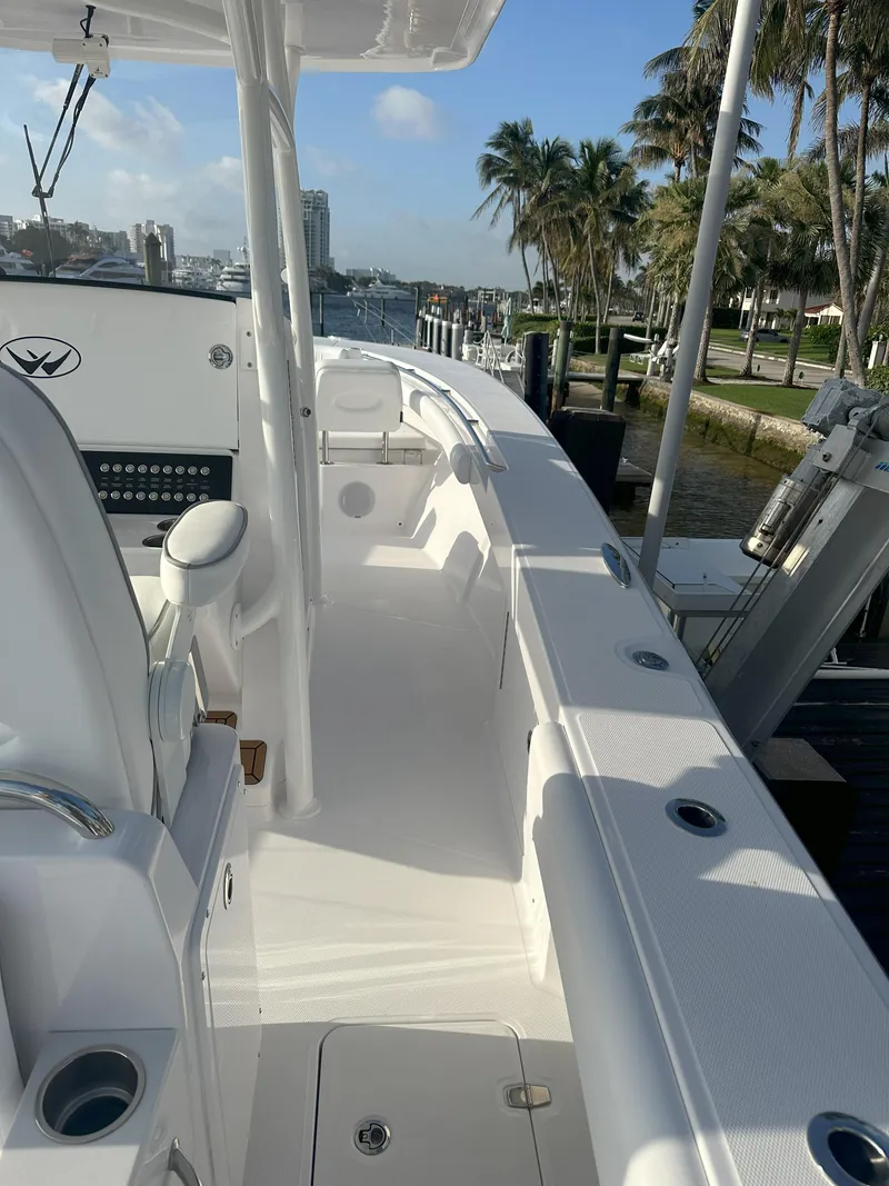 Slide: The Image of 2024 Southport 30 FE boat docked, featuring sleek white deck and modern amenities. - 7