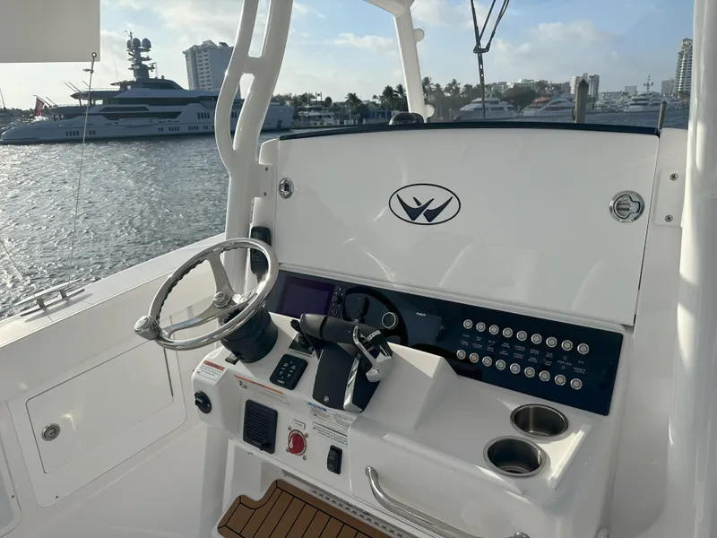 Slide: The Image of 2024 Southport 30 FE boat helm with modern controls and waterfront view. - 9