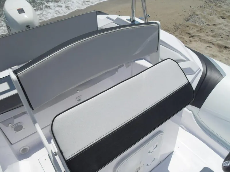 Slide: The Image of 2025 Ranieri CAYMAN 19 Sport boat seating area with white and black cushions. - 17