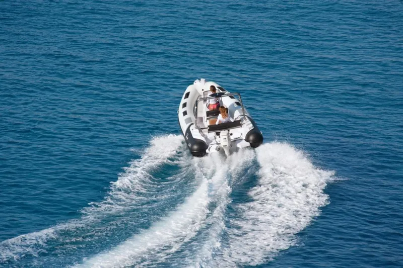 Slide: The Image of 2025 Ranieri CAYMAN 19 Sport boat cruising on clear blue water. - 6