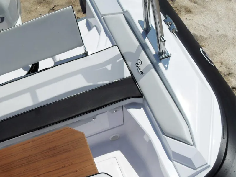 Slide: The Image of 2025 Ranieri CAYMAN 19 Sport boat interior with seating and wooden table. - 9