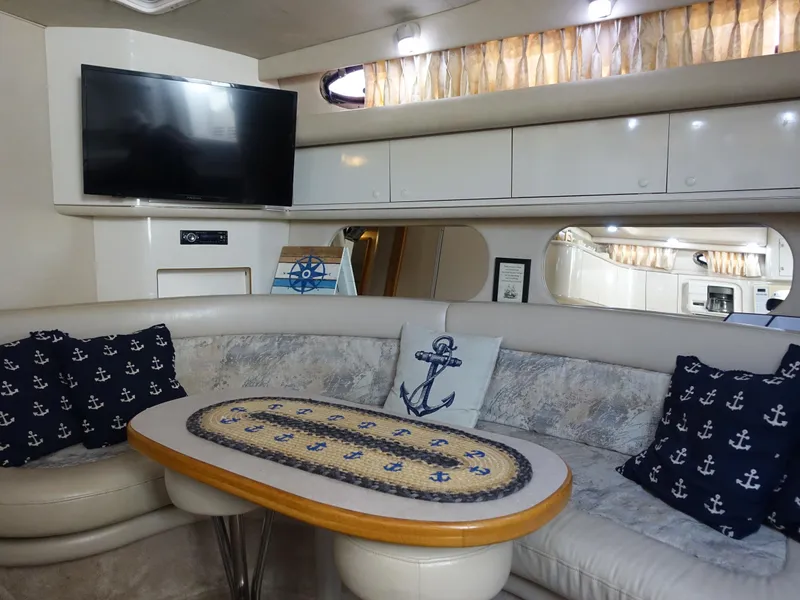 Slide: The Image of Interior of 1996 Sea Ray 370 Sundancer with nautical decor and modern amenities. - 10