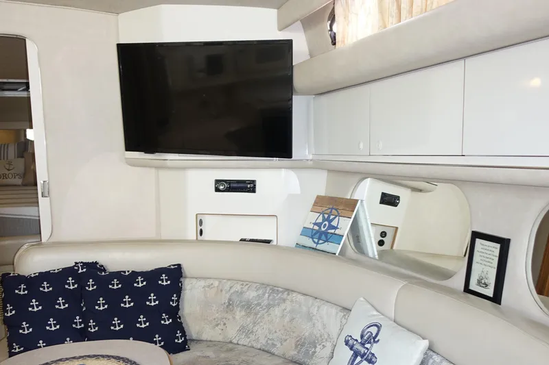 Slide: The Image of Interior of 1996 Sea Ray 370 Sundancer with TV and nautical-themed decor. - 11