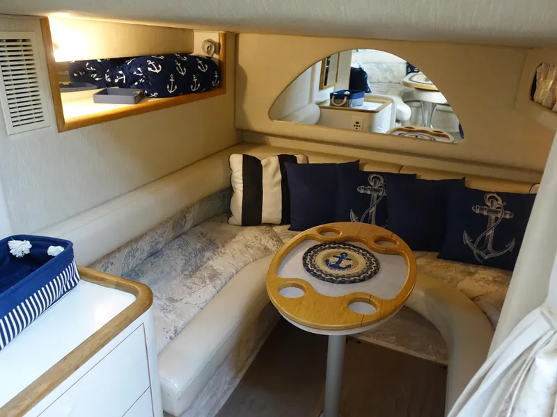 Slide: The Image of Cozy interior of 1996 Sea Ray 370 Sundancer with nautical-themed decor. - 15