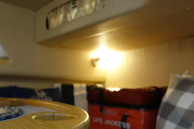 Slide: The Image of Interior of 1996 Sea Ray 370 Sundancer with life jackets and cozy seating. - 16