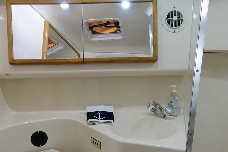 Slide: The Image of Bathroom interior of 1996 Sea Ray 370 Sundancer with mirror and sink. - 19