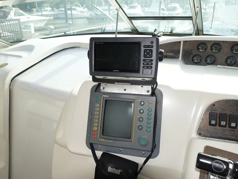 Slide: The Image of 1996 Sea Ray 370 Sundancer helm with navigation equipment and controls. - 2