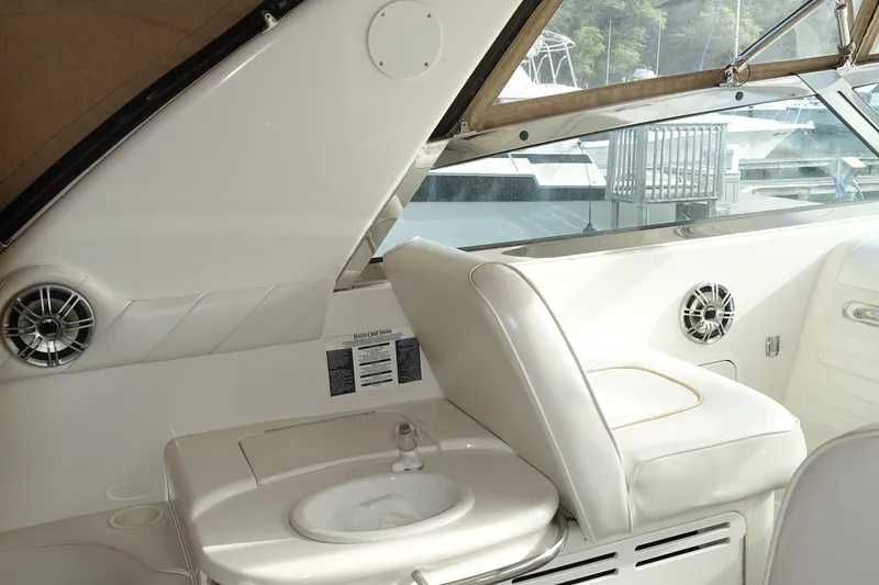Slide: The Image of Interior of 1996 Sea Ray 370 Sundancer yacht with white seating and built-in sink. - 3