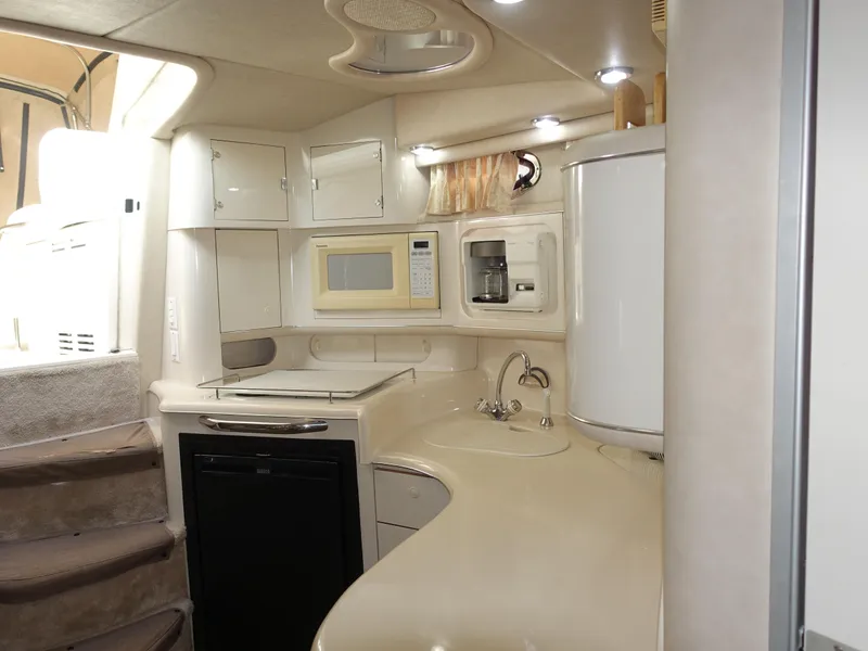Slide: The Image of Interior of 1996 Sea Ray 370 Sundancer yacht kitchen with modern appliances. - 6
