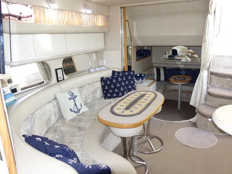 Slide: The Image of Interior of 1996 Sea Ray 370 Sundancer yacht with nautical-themed decor and seating area. - 8