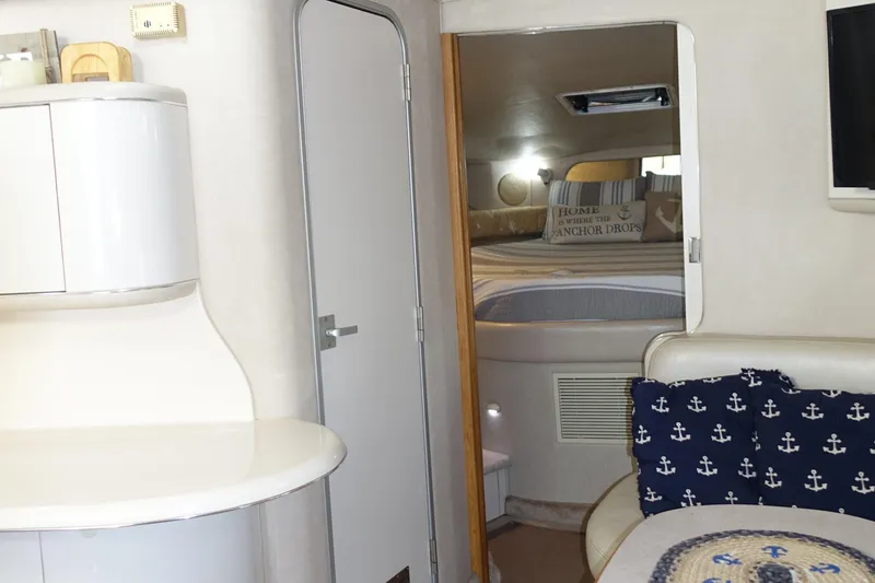 Slide: The Image of Interior of 1996 Sea Ray 370 Sundancer yacht with cozy cabin and nautical decor. - 9