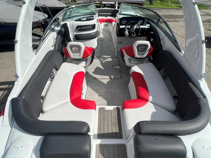 Slide: The Image of 2022 Crownline 265 SS boat interior with red and white seating, modern dashboard. - 5