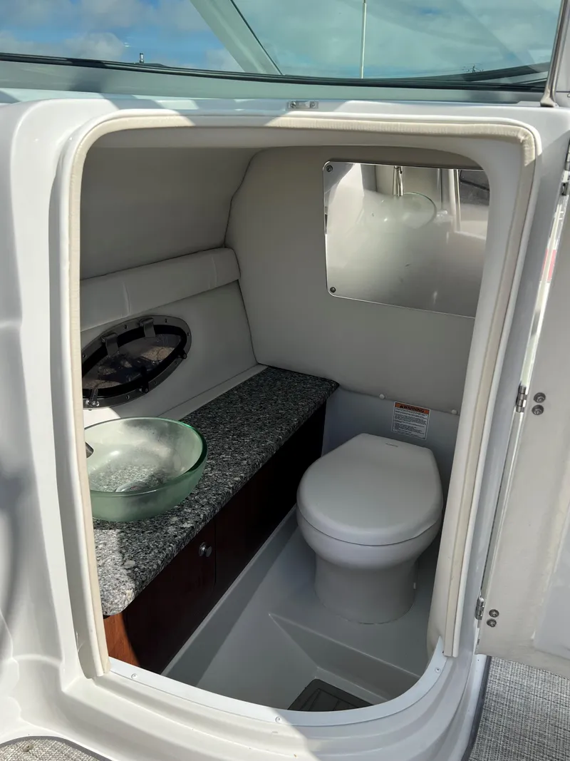 Slide: The Image of 2022 Crownline 265 SS boat interior bathroom with sink and toilet. - 7