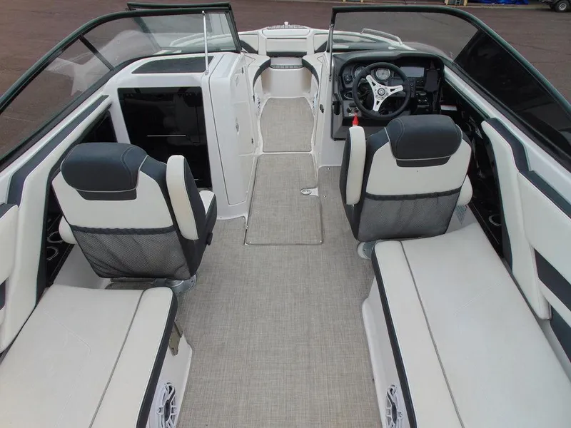 Slide: The Image of 2016 Yamaha Boats 242 Limited interior with seating and steering console. - 4