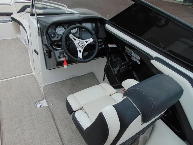Slide: The Image of 2016 Yamaha Boats 242 Limited cockpit with steering wheel and captain's chair. - 6