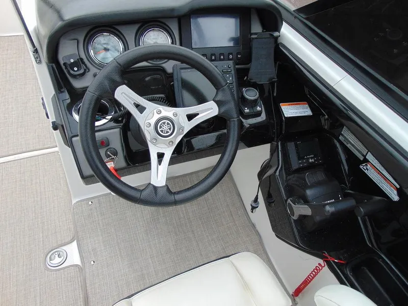 Slide: The Image of 2016 Yamaha Boats 242 Limited steering console with gauges and controls. - 7