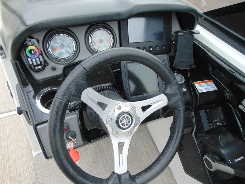 Slide: The Image of Steering console of a 2016 Yamaha Boats 242 Limited with gauges and controls. - 8