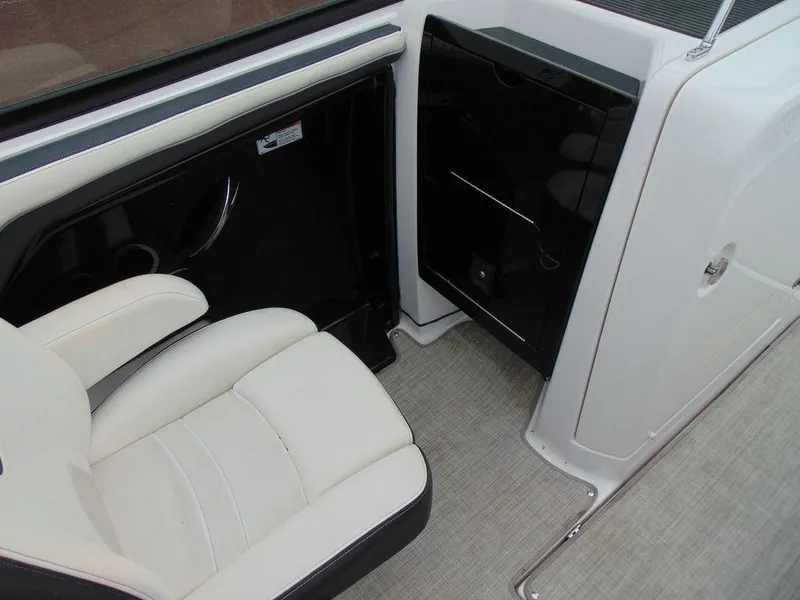 Slide: The Image of Interior of 2016 Yamaha Boats 242 Limited, featuring white seating and black storage compartment. - 9