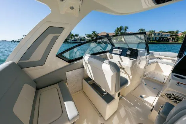 Slide: The Image of 2021 Scout 277 Dorado boat interior with helm and seating area. - 13