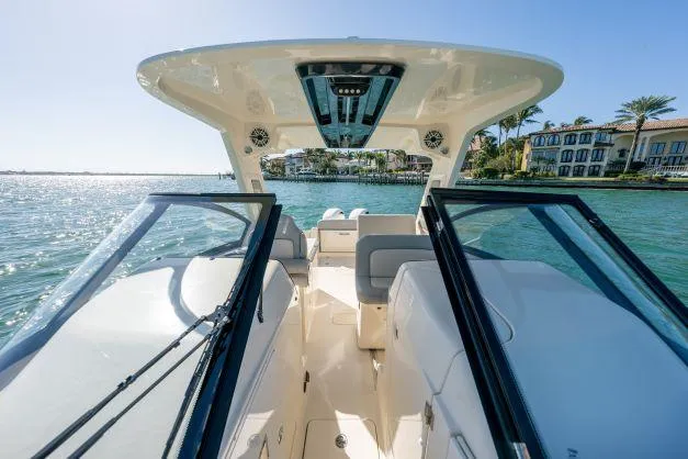 Slide: The Image of 2021 Scout 277 Dorado boat interior with open water and luxury homes in the background. - 16