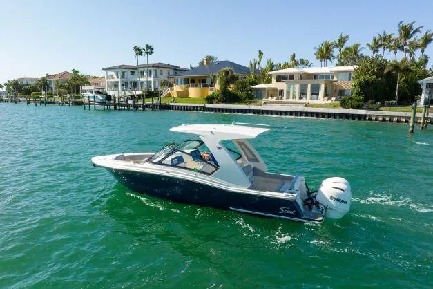 Slide: The Image of 2021 Scout 277 Dorado boat cruising near waterfront homes. - 22