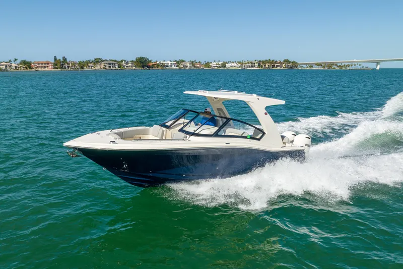 Slide: The Image of 2021 Scout 277 Dorado boat cruising on clear blue water. - 34
