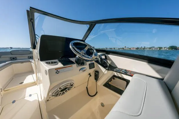 Slide: The Image of 2021 Scout 277 Dorado boat cockpit with steering wheel and dashboard. - 9