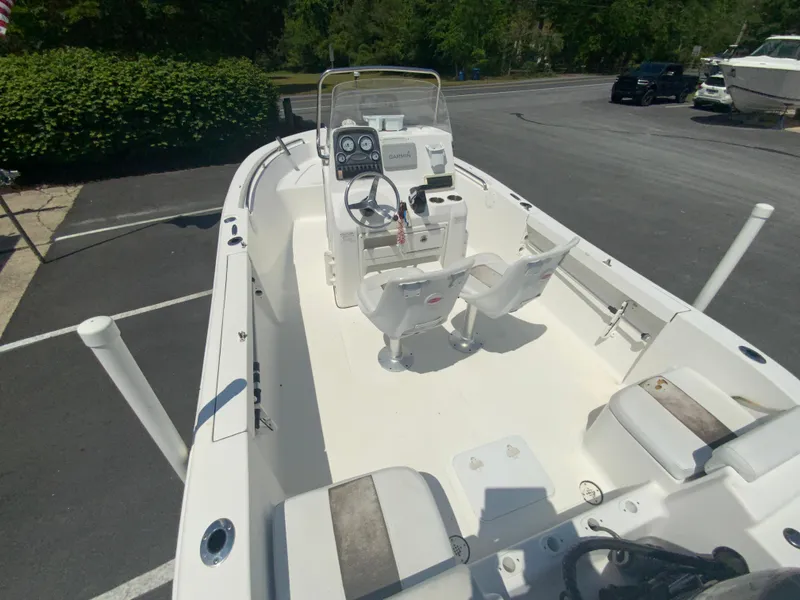 Slide: The Image of 2014 Tidewater 196 CC Adventure boat with center console and seating, parked on asphalt. - 10